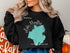 Black sweatshirt with "Beautiful Lake Moultrie South Carolina" map graphic.