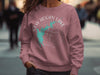 Pink sweatshirt with New Hogan Lake California compass graphic and lake silhouette.