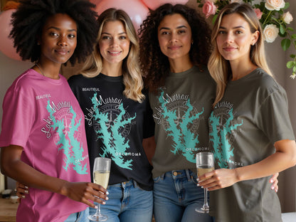 Four women wearing t-shirts with "Lake Murray Oklahoma" design and holding champagne flutes.