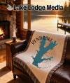 Fringed blanket with Rend Lake Illinois map design on a leather couch.
