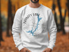 White sweatshirt with Trinity Lake California map and compass graphic.