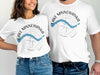 White t-shirts with "Lake Minnewanka Banff" text and abstract compass design.