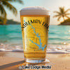 Pint glass with "Candleman Lake" and compass design on a beach with palm trees.