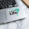 Rushford Life sticker with a teal state outline on a laptop keyboard.