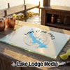 A rectangular glass cutting board featuring a blue map of Lake O' The Pines, Texas, with a compass design.