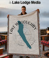 Woven blanket with Lake Willoughby map and Vermont text, held by a man.