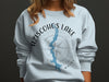 Aziscohos Lake Maine graphic with compass on a light blue sweatshirt.