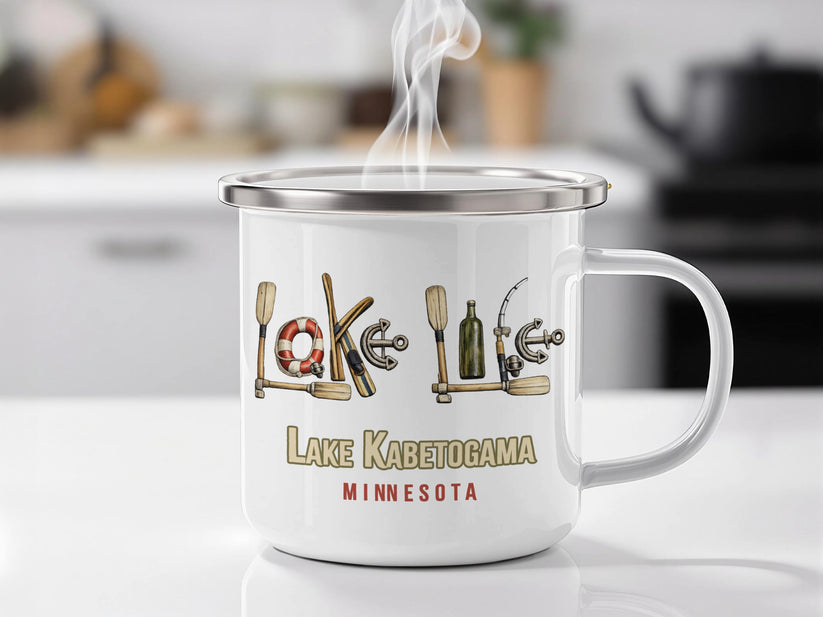 White enamel mug with "Lake Kab2toga Minnesota" and lake-themed graphics.