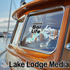 Sticker on boat window reads "Watts Bar Life" with map; "Lake Lodge Media" logo below.