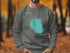Gray sweatshirt with a teal map of Hauser Lake, Idaho graphic.