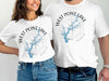White t-shirts featuring a compass rose design with blue lake map and text.
