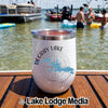 A white travel tumbler with a Degray Lake, Arkansas logo resting on a wooden dock.