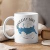 White mug with Rangeley Lake, Maine map and compass graphic, steaming gently.