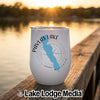 A white insulated tumbler featuring a blue outline of Pavlas Lake, Wisconsin, resting on a wooden dock.