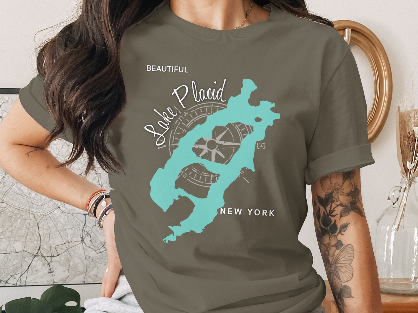 T-shirt featuring a teal map of Lake Placid and a compass rose.