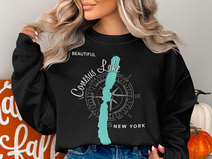 Black sweatshirt with "Beautiful Conesus Lake New York" compass graphic.