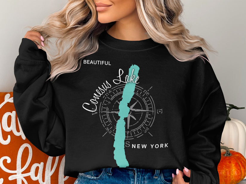 Black sweatshirt with "Beautiful Conesus Lake New York" compass graphic.