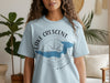 Light blue t-shirt with "Lake Crescent Washington" text and a blue lake map on a compass graphic.