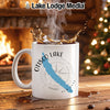 White mug with "OTISCO LAKE NEW YORK" and compass design, steaming coffee splashing.