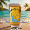 Beer glass with blue map shape and text "KER CANYON LA ARIZO" on beach.
