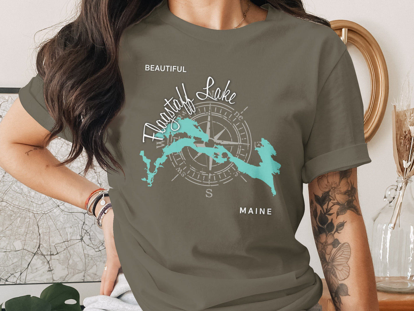 T-shirt featuring a turquoise map of Flagstaff Lake, Maine, with a compass rose.