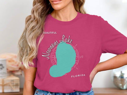 Woman wearing pink t-shirt with teal Neumann's Lake map and Florida text.