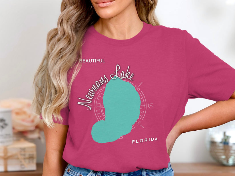 Woman wearing pink t-shirt with teal Neumann's Lake map and Florida text.