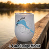 A white stainless steel tumbler rests on a wooden dock with a compass and Bow Lake, Alberta design.