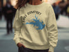 Light yellow crewneck sweatshirt with Lake Rampart Colorado map and compass design.