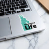 Turquoise sticker with "Wanafoo Life" text on a laptop.