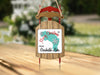 Sled ornament with "Merry Christmas from Garibaldi Lake" text and snowflakes.