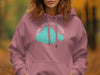 Pink hoodie with a turquoise Lake Pontchartrain graphic and compass detail.
