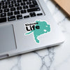 Teal Simcoe Life sticker on a laptop keyboard with marble background.