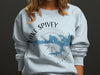 White sweatshirt featuring a blue map of Lake Spivey, Georgia, and compass design.