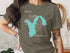 Green t-shirt with turquoise outline of Lake Union, Washington and compass rose.