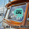 Teal sticker with "Hefner Life" on a wooden boat window.