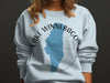 Light blue sweatshirt with "Lake Winnebago Wisconsin" text and compass design.