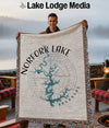 Man holding a Norfork Lake Arkansas map blanket with compass rose design.