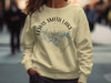 Light tan sweatshirt with Lewis Smith Lake Alabama compass graphic and text.