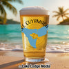 Beer glass with "Lake Cuyamaca" and California map on beach with palm trees.