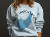 Light blue sweatshirt with Rose Canyon Lake Arizona map graphic and compass design.
