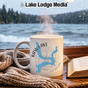 White mug with Kaw Lake Oklahoma map and compass on a windowsill with a book and scarf.