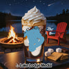 Dessert with whipped cream and s'mores ingredients by a campfire.