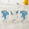 Three glasses with blue map designs of Lake Huron and text, on a marble surface.