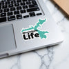 Turquoise Nantahala Life sticker on a laptop keyboard.