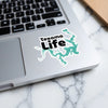 Texoma Life sticker with lake outline on a laptop keyboard