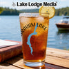 Glass with iced tea, lemon slice, and "Graham Lake" design on a wooden table.