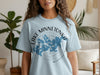 Light blue t-shirt with "Lake Minnetonka Minnesota" and map in grey and blue on front.