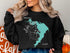 Black sweatshirt with turquoise map graphic of Lake Waco, Texas.
