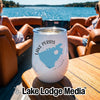 A white insulated wine tumbler with a Lake Perris map graphic sits on a wooden boat table.